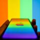 iPhone with rainbow Apple logo against test pattern