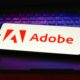 The Adobe Inc. logo displayed on a smartphone screen.