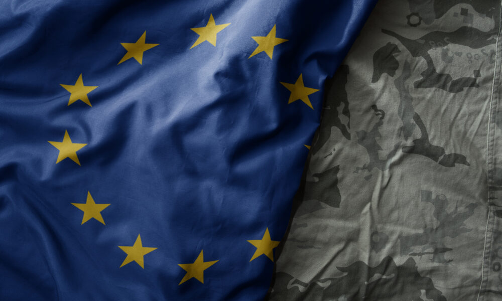 colourful waving flag of european union on the old khaki texture background. military concept.