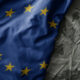 colourful waving flag of european union on the old khaki texture background. military concept.