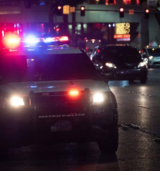 police car flashing lights dark city street