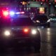 police car flashing lights dark city street