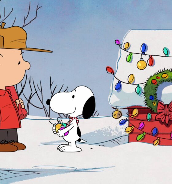 Image of Charlie Brown and Snoopy standing by the decorated doghouse in '12 Days of Snoopy'