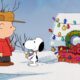 Image of Charlie Brown and Snoopy standing by the decorated doghouse in '12 Days of Snoopy'