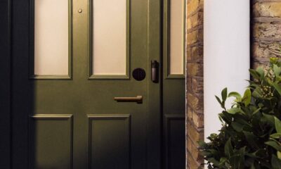 Smart Deadbolt Lock and Video Doorbell are featured on a dark green front door.