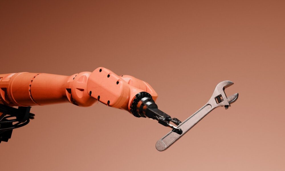 Conceptual image of a robotic arm holding a wrench.