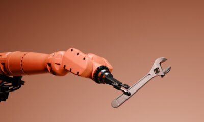 Conceptual image of a robotic arm holding a wrench.