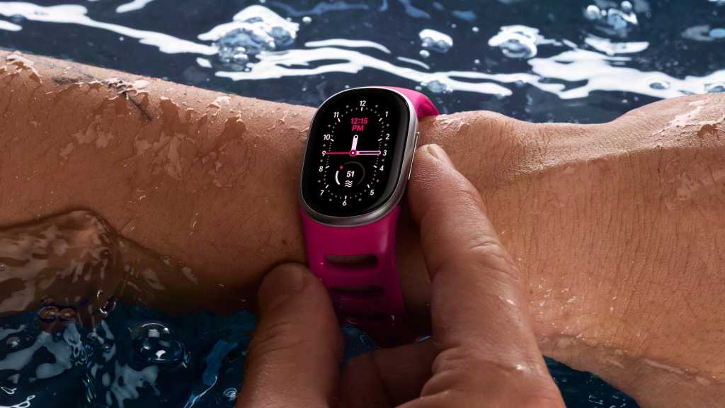 Google Fitbit Edge fitness tracker in a swimming pool