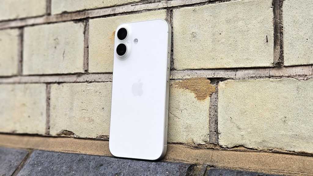 iPhone 17 in white, against a brick wall